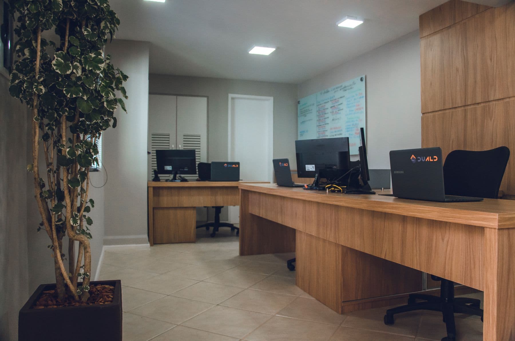 Organized modern office with wooden desks and computer workstations