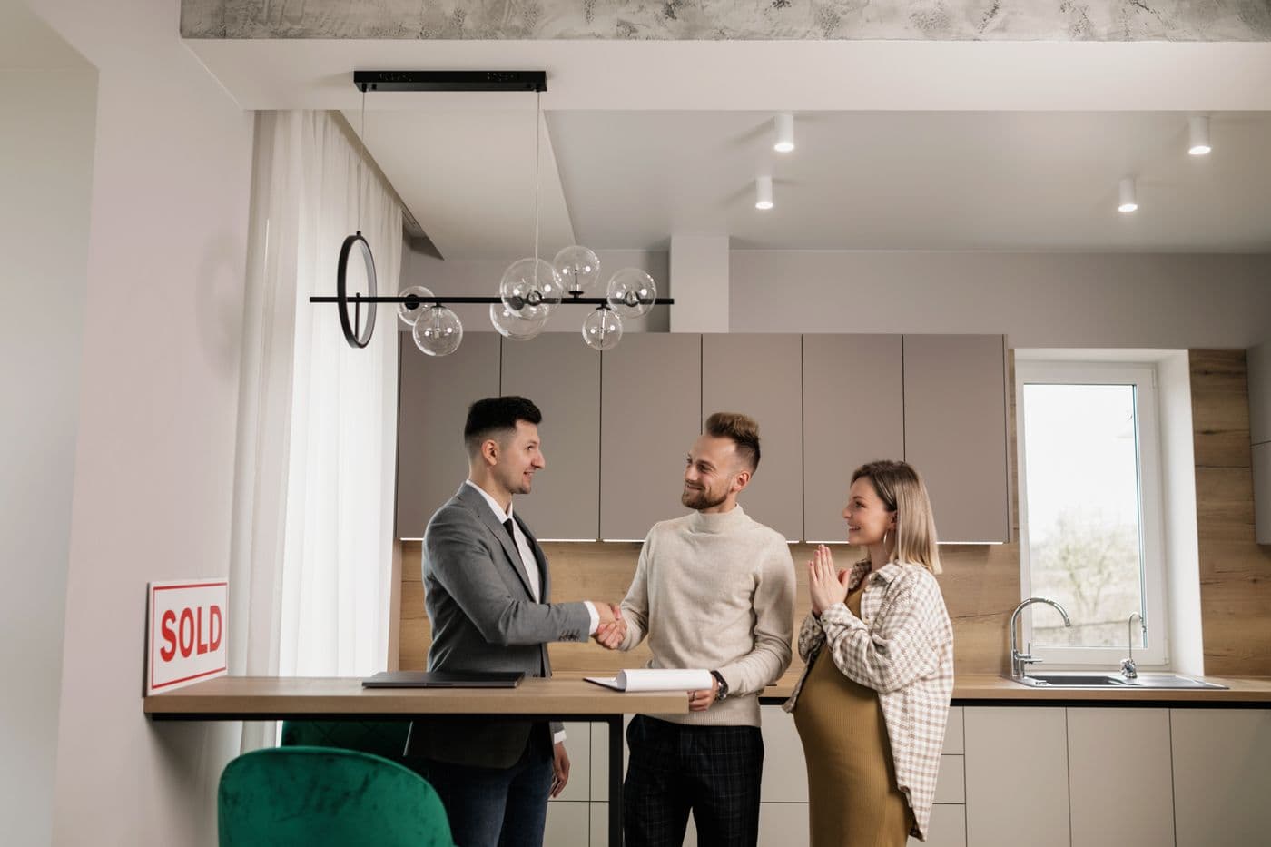 Property buyers and an agent meeting in a newly prepared unit