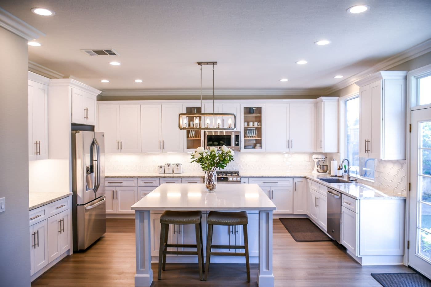 Clean, bright kitchen with white cabinets and an island